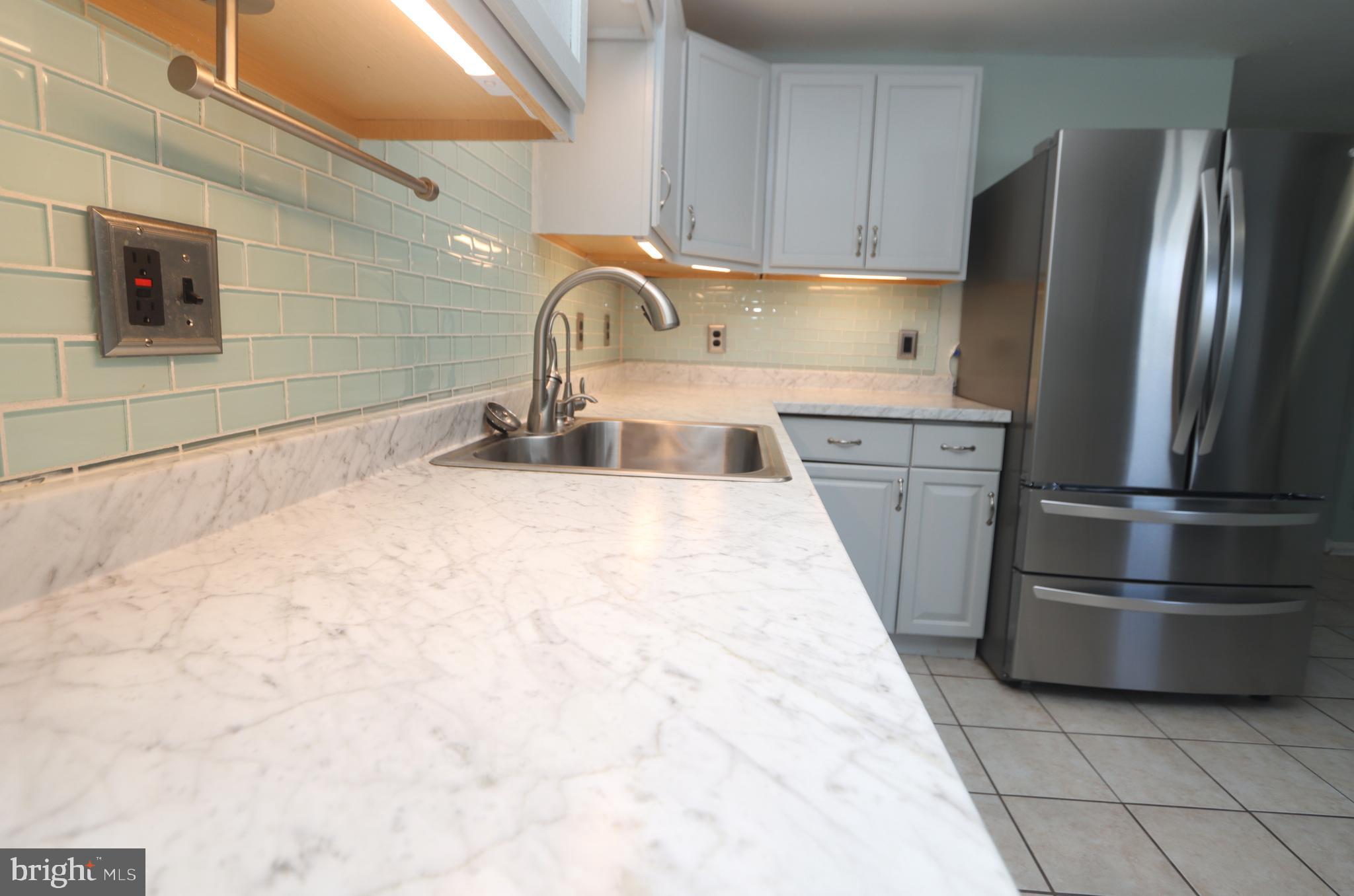 1012 Wells Street Conshohocken, PA 19428 - Photo 9 of 29 a kitchen with stainless steel appliances granite countertop a refrigerator and a sink