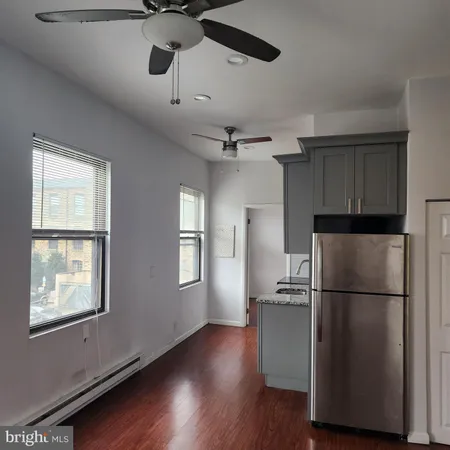 a kitchen with stainless steel appliances granite countertop a refrigerator a sink and a window