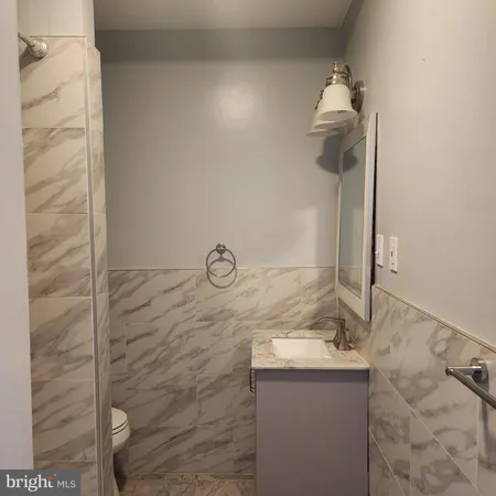 a bathroom with a granite countertop sink and mirror