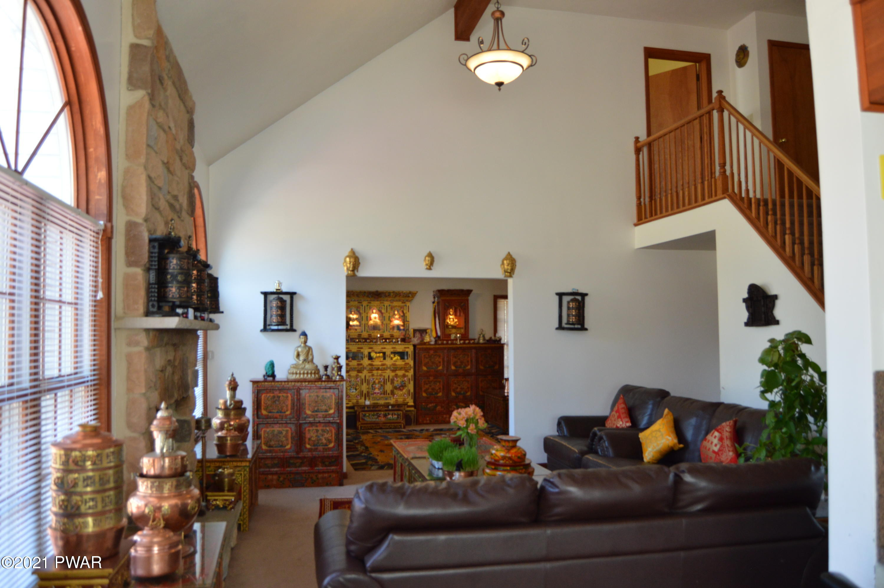 4281 Pne Rdg Drive Bushkill, PA 18324 - Photo 13 of 30 a living room with furniture flowerpot and a chandelier