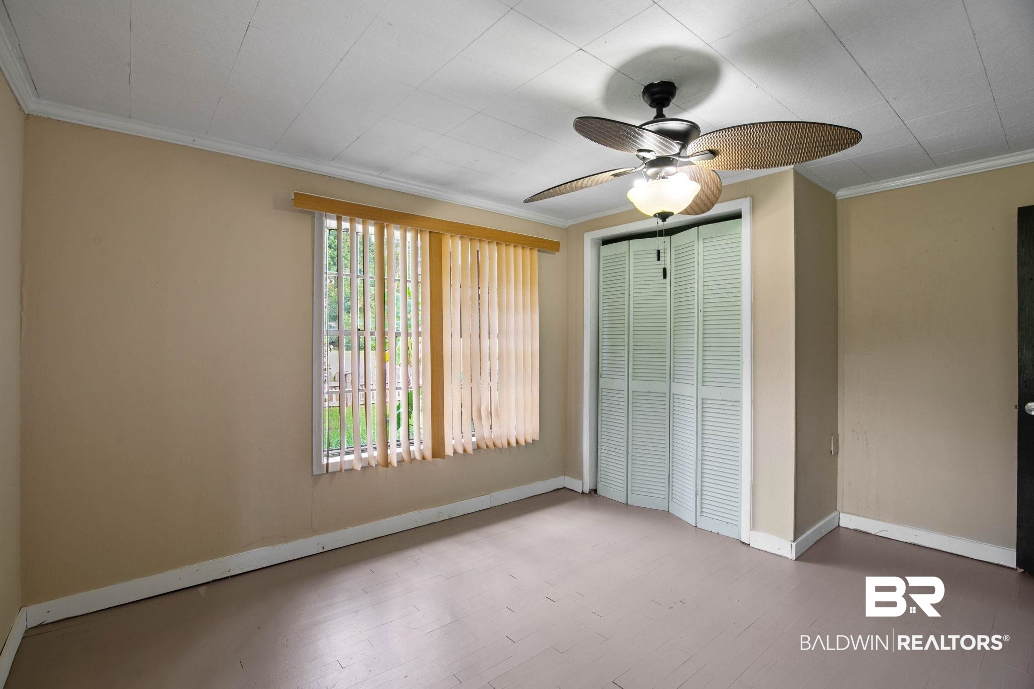 23240 County Road 47 Perdido, AL 36562 - Photo 20 of 29 Unfurnished bedroom featuring ornamental molding, a ceiling fan, a closet, and wood finished floors