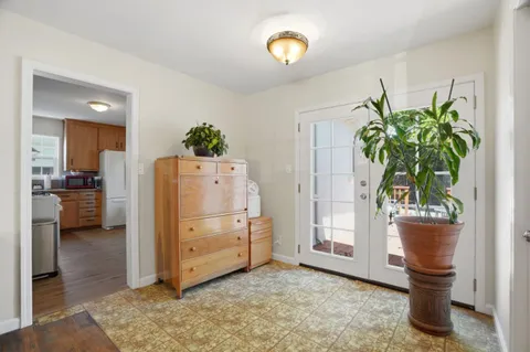 a view of kitchen with furniture and refrigerator