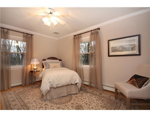 58 Stanton Road Darien, CT 06820 - Photo 12 of 17 a bedroom with a bed and a chandelier