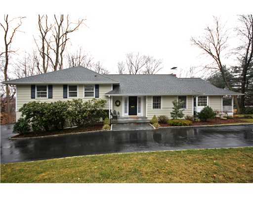 58 Stanton Road Darien, CT 06820 - Photo 17 of 17 a front view of a house with a yard table and chairs