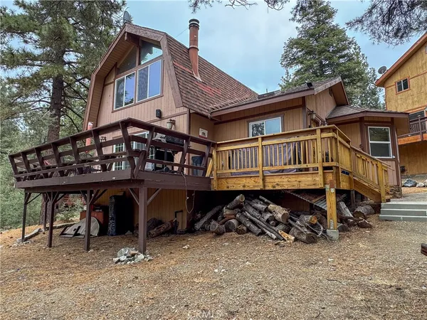 a view of a house with wooden deck