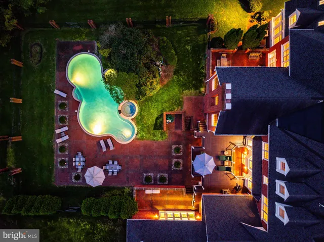 an aerial view of a house with swimming pool yard and outdoor seating