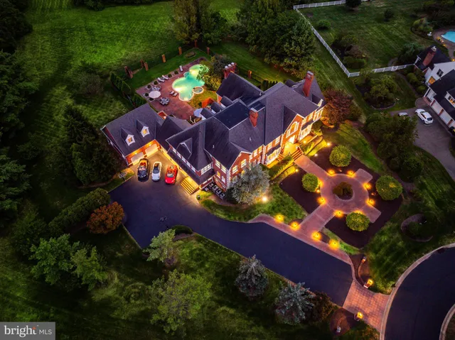 an aerial view of a house a yard swimming pool outdoor seating and yard