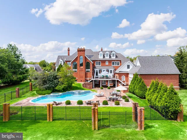 a aerial view of a house with a yard table and chairs