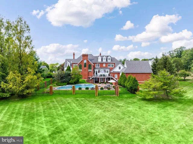a view of a house with a big yard and a large tree