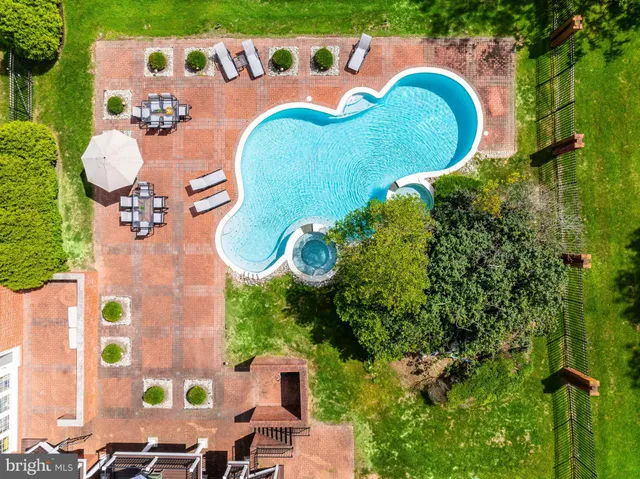 an aerial view of a house swimming pool and outdoor seating