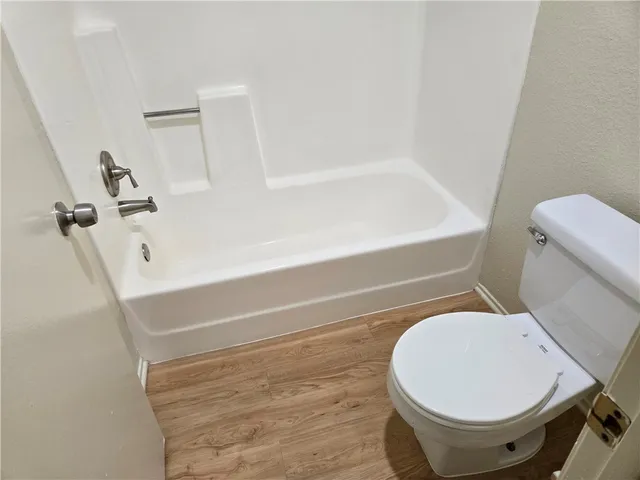 a bathroom with a toilet and a bathtub