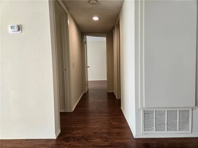 a view of hallway with wooden floor