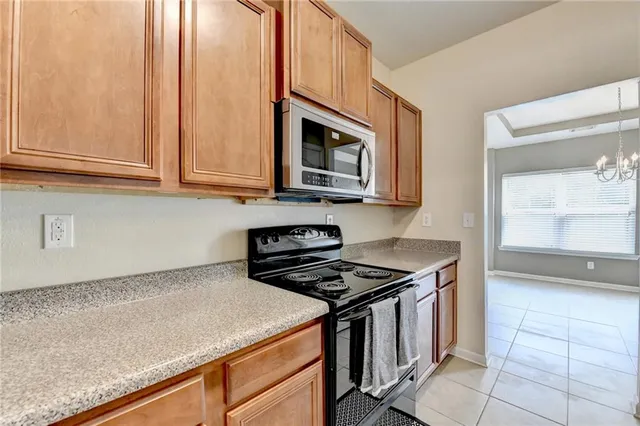 a kitchen with stainless steel appliances granite countertop a stove and a microwave