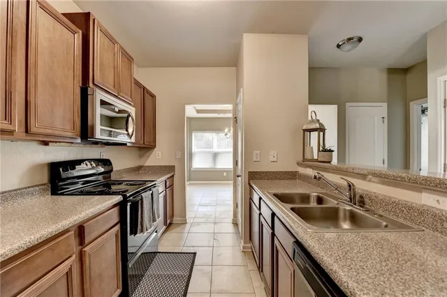 a kitchen that has a sink and a stove
