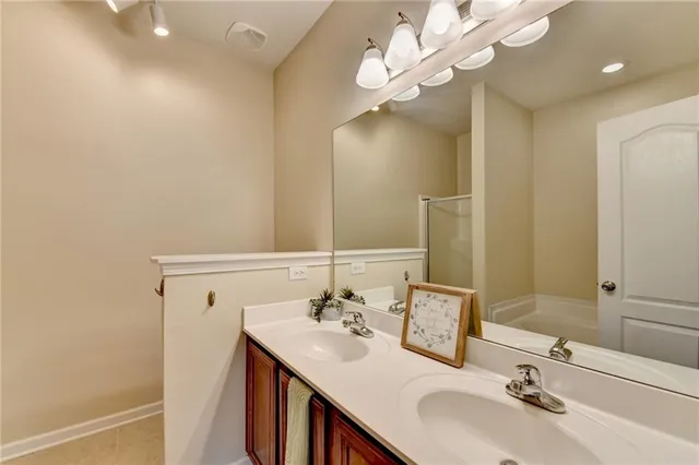 a bathroom with a sink a light fixture and a mirror
