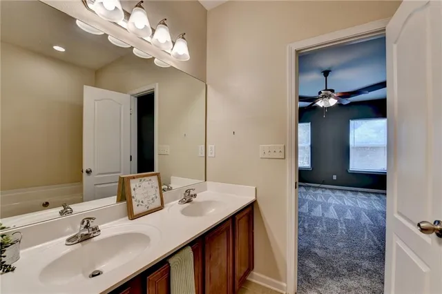 a bathroom with a sink a vanity and a mirror