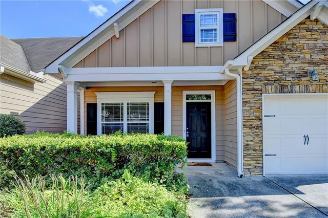 a view of a house with potted plants