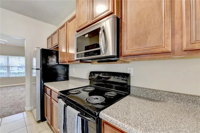 a kitchen with stainless steel appliances granite countertop a stove and a microwave