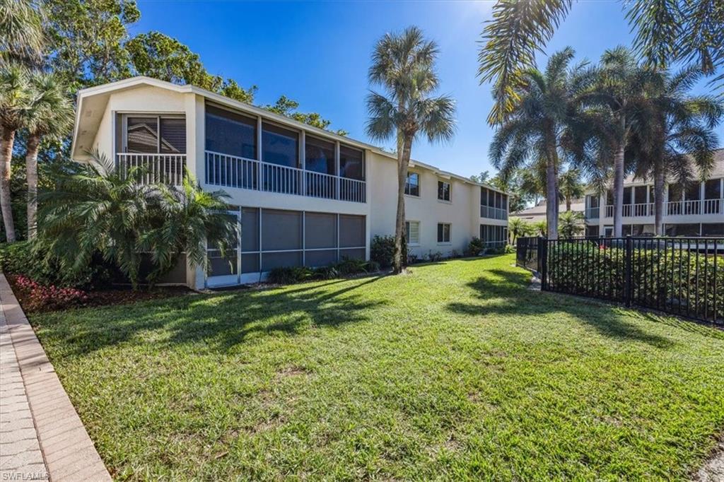 3200 Binnacle Drive, Unit C4 Naples, FL 34103 - Photo 24 of 24 View of yard featuring a sunroom and fence