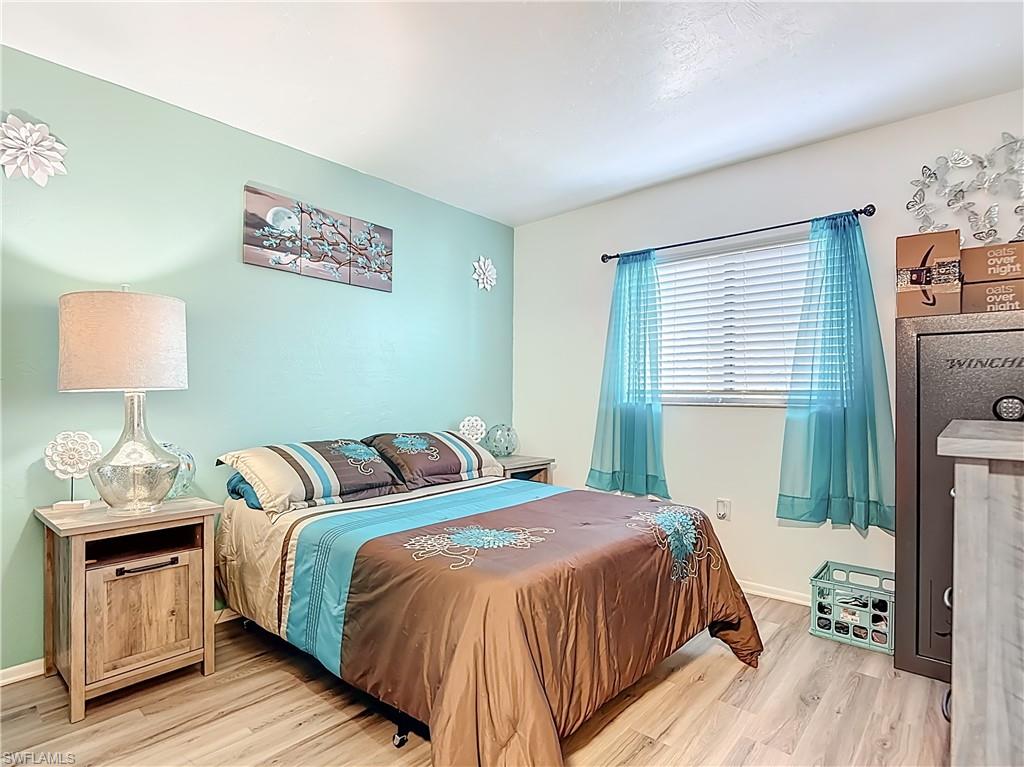 1201 Barrett Road, Unit 1204 North Fort Myers, FL 33903 - Photo 19 of 31 a bedroom with a bed and wooden floor