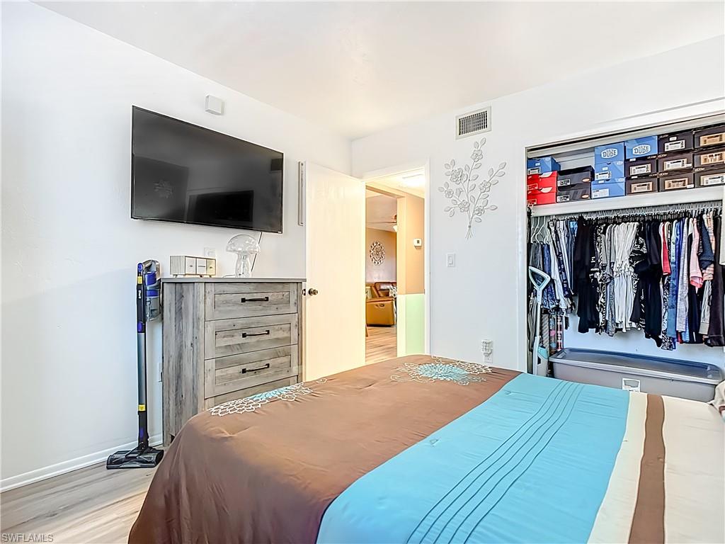 1201 Barrett Road, Unit 1204 North Fort Myers, FL 33903 - Photo 20 of 31 a bedroom with a bed and a flat screen tv