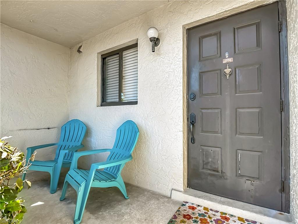 1201 Barrett Road, Unit 1204 North Fort Myers, FL 33903 - Photo 5 of 31 a chair and a table in a room
