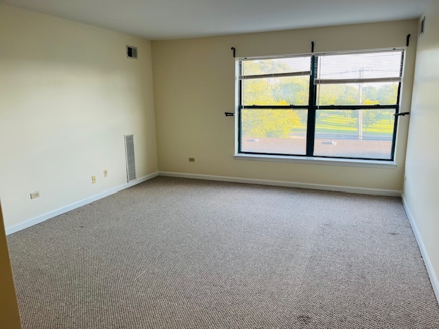 3275 Kirchoff Road, Unit 337 Rolling Meadows, IL 60008 - Photo 2 of 10 an empty room with a window