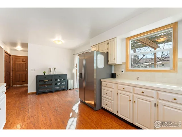 a kitchen with stainless steel appliances a refrigerator and a cabinets
