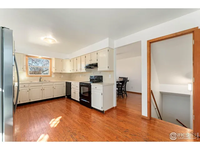 a kitchen with a cabinets and wooden floor