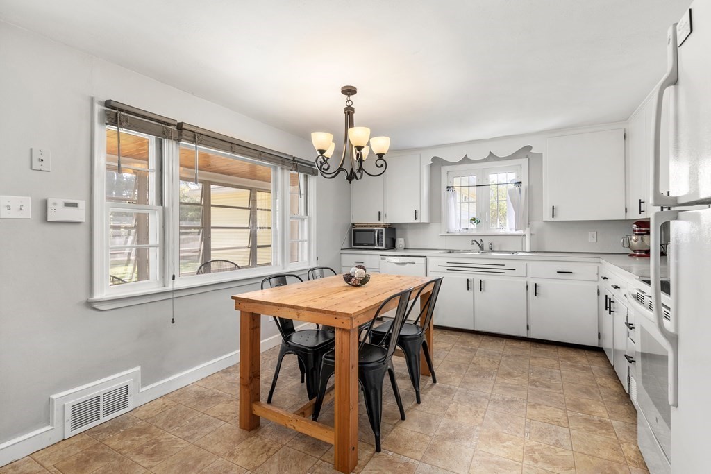 53 Wilson Street Ludlow, MA 01056 - Photo 11 of 26 a kitchen that has a lot of white cabinets and wooden floor