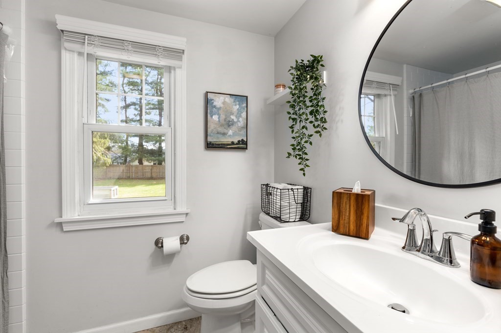 53 Wilson Street Ludlow, MA 01056 - Photo 16 of 26 a bathroom with a toilet sink and mirror