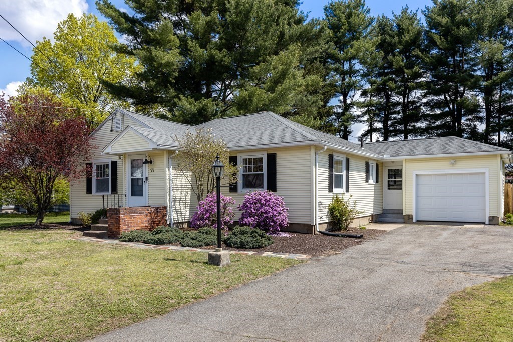 53 Wilson Street Ludlow, MA 01056 - Photo 2 of 26 a front view of a house with a garden and porch