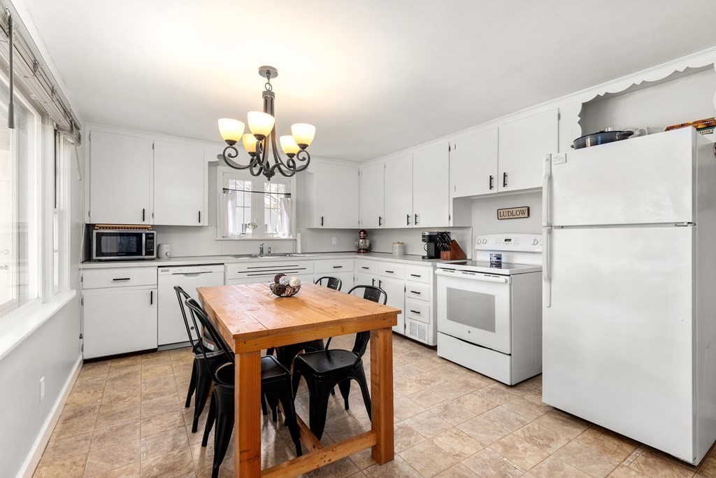 53 Wilson Street Ludlow, MA 01056 - Photo 10 of 26 a kitchen with white cabinets and white appliances