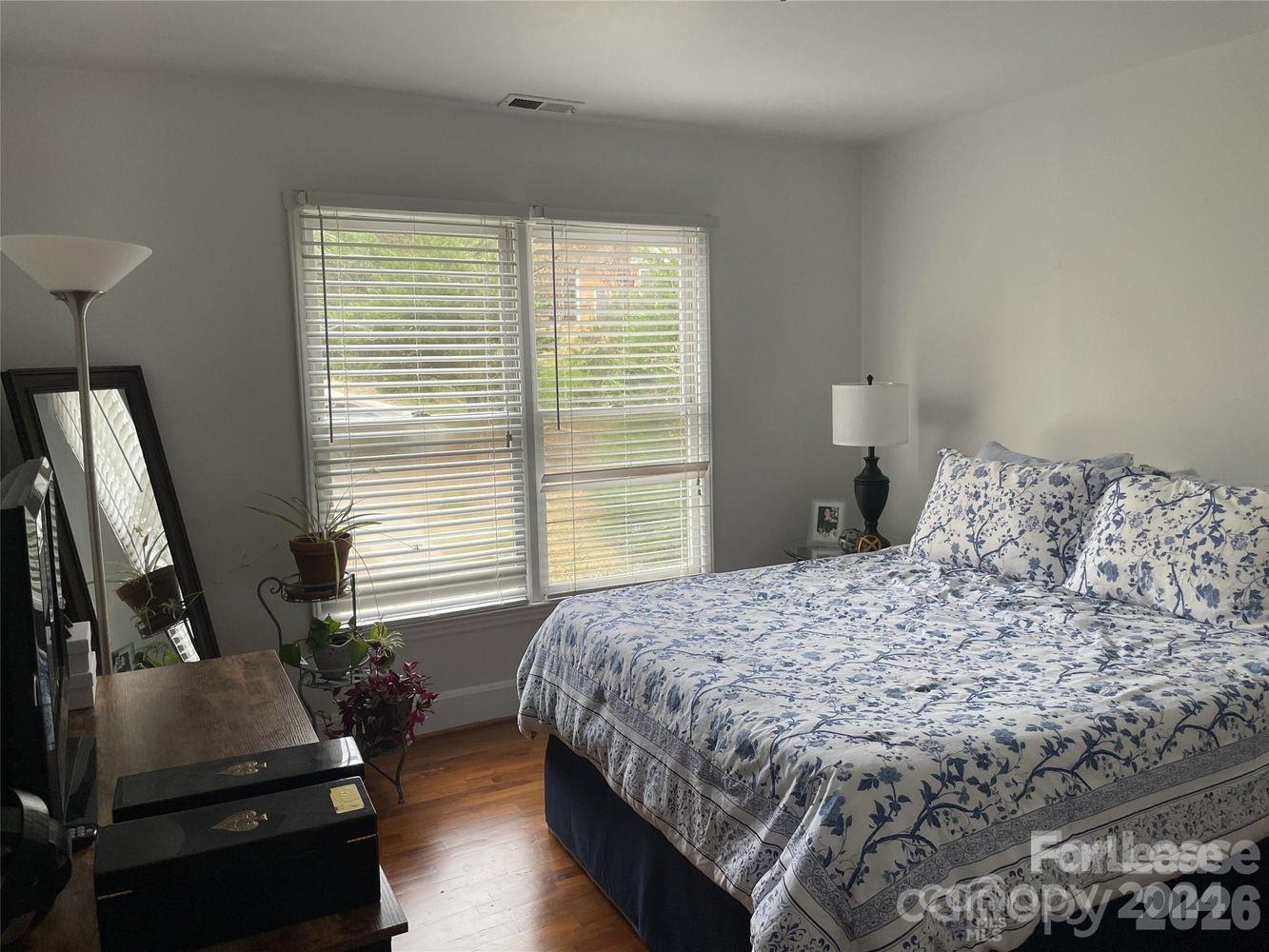 3800 Oldfield Road Charlotte, NC 28226 - Photo 23 of 32 a bedroom with a bed and a night stand