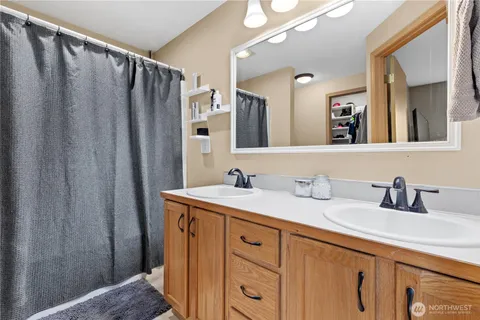 a bathroom with a double vanity sink and mirror