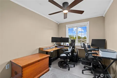 a view of a workspace with furniture and a window