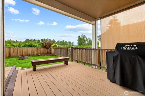a view of a wooden deck with a yard
