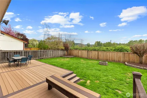 a view of a backyard with sitting area