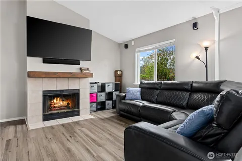 a living room with furniture a flat screen tv and a fireplace