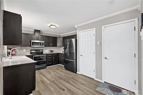 a kitchen with a refrigerator stove and sink