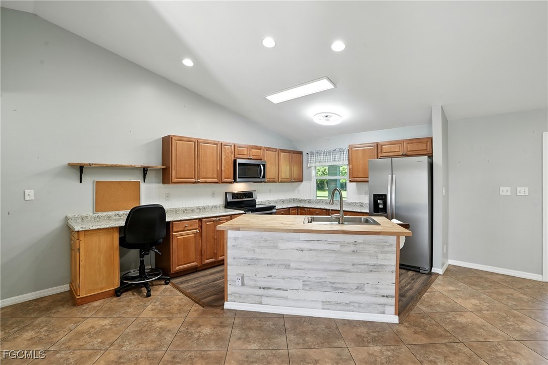 2373 Summerall Road LaBelle, FL 33935 - Photo 11 of 47 a kitchen with a stove a refrigerator and washer