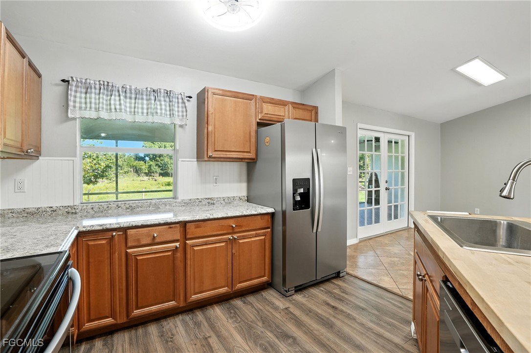 2373 Summerall Road LaBelle, FL 33935 - Photo 12 of 47 a kitchen with stainless steel appliances granite countertop a refrigerator and a sink