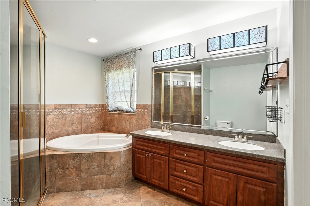 2373 Summerall Road LaBelle, FL 33935 - Photo 18 of 47 a bathroom with a sink double vanity and a mirror