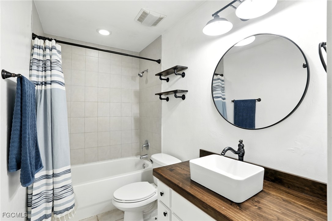 2373 Summerall Road LaBelle, FL 33935 - Photo 23 of 47 a bathroom with a sink a toilet and a mirror