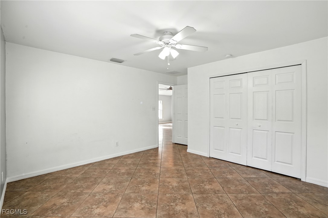 2373 Summerall Road LaBelle, FL 33935 - Photo 25 of 47 wooden floor in an empty room with a fan