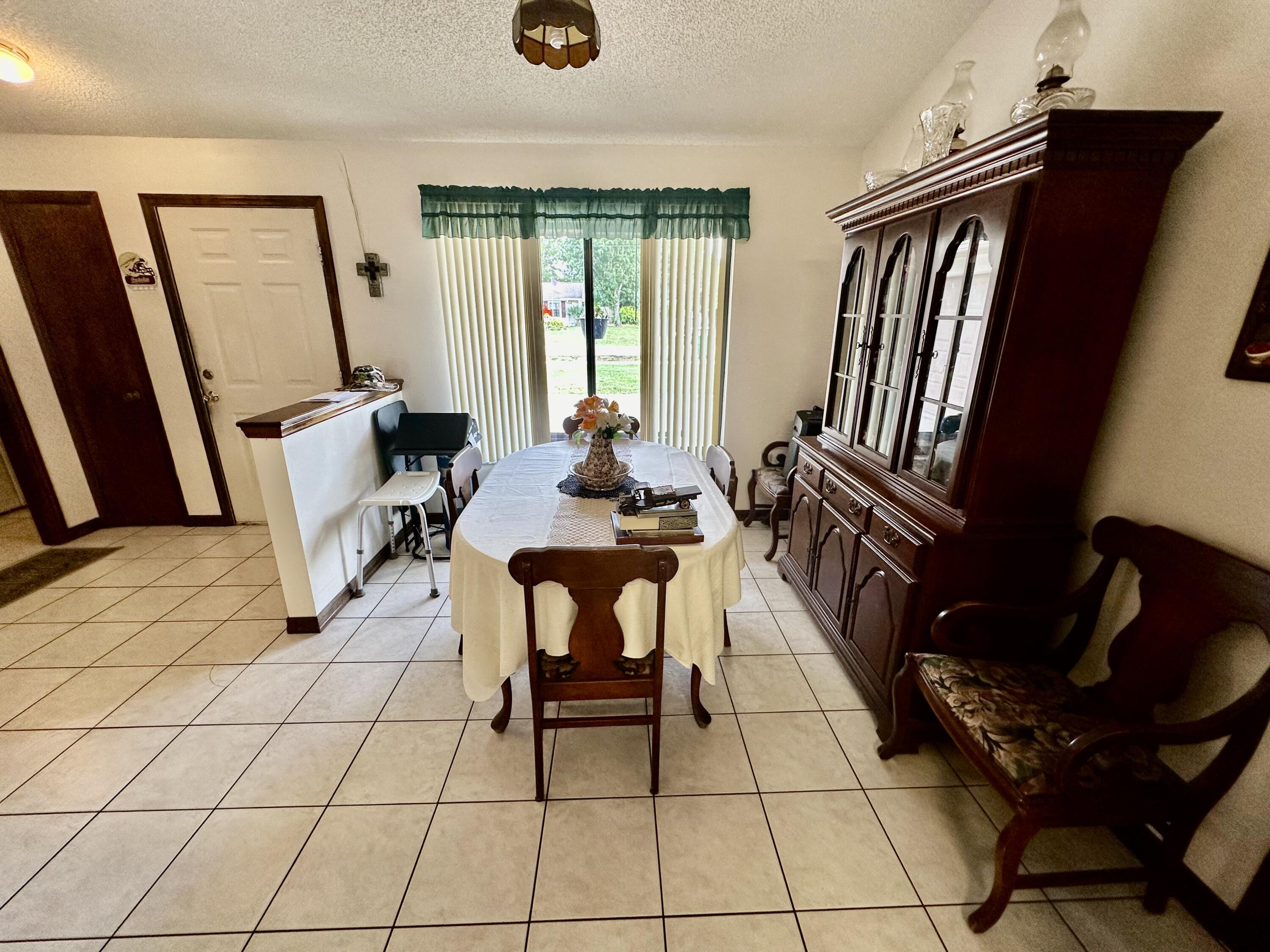 4980 Bridge Road Cocoa, FL 32927 - Photo 11 of 24 a dining room with furniture and wooden floor