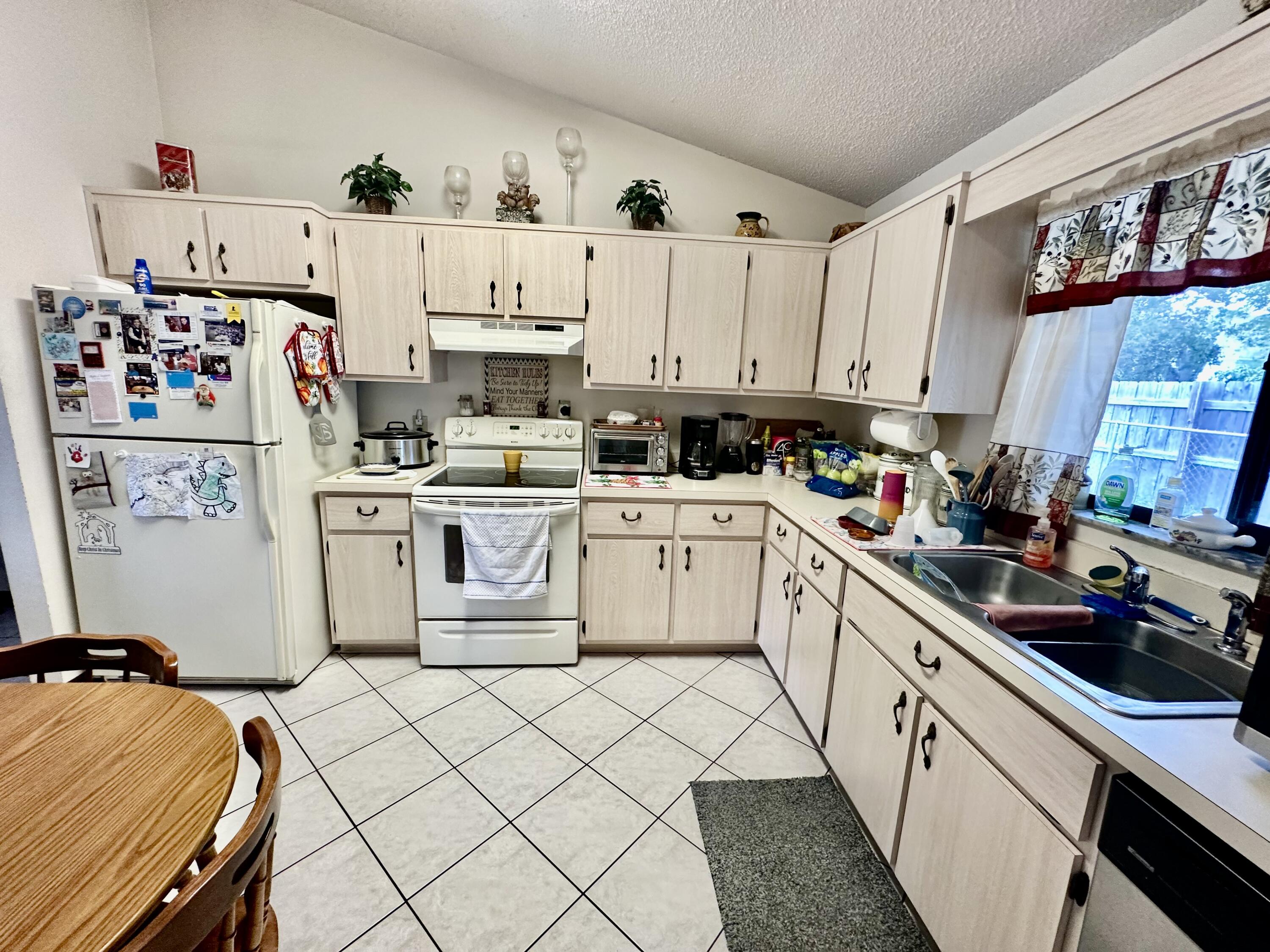 4980 Bridge Road Cocoa, FL 32927 - Photo 12 of 24 a kitchen with a white cabinets and white appliances