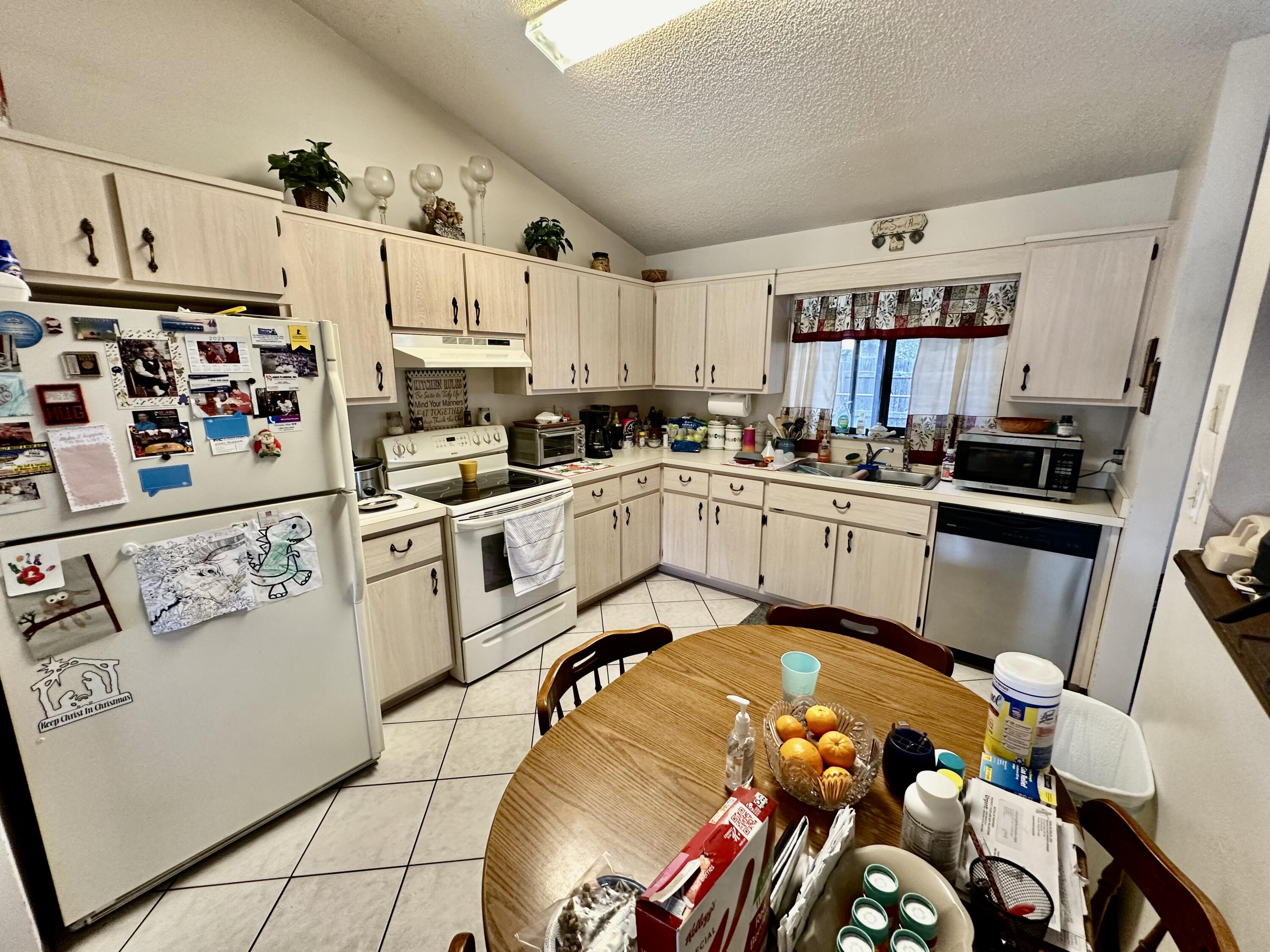 4980 Bridge Road Cocoa, FL 32927 - Photo 13 of 24 a kitchen with wooden cabinets and sink