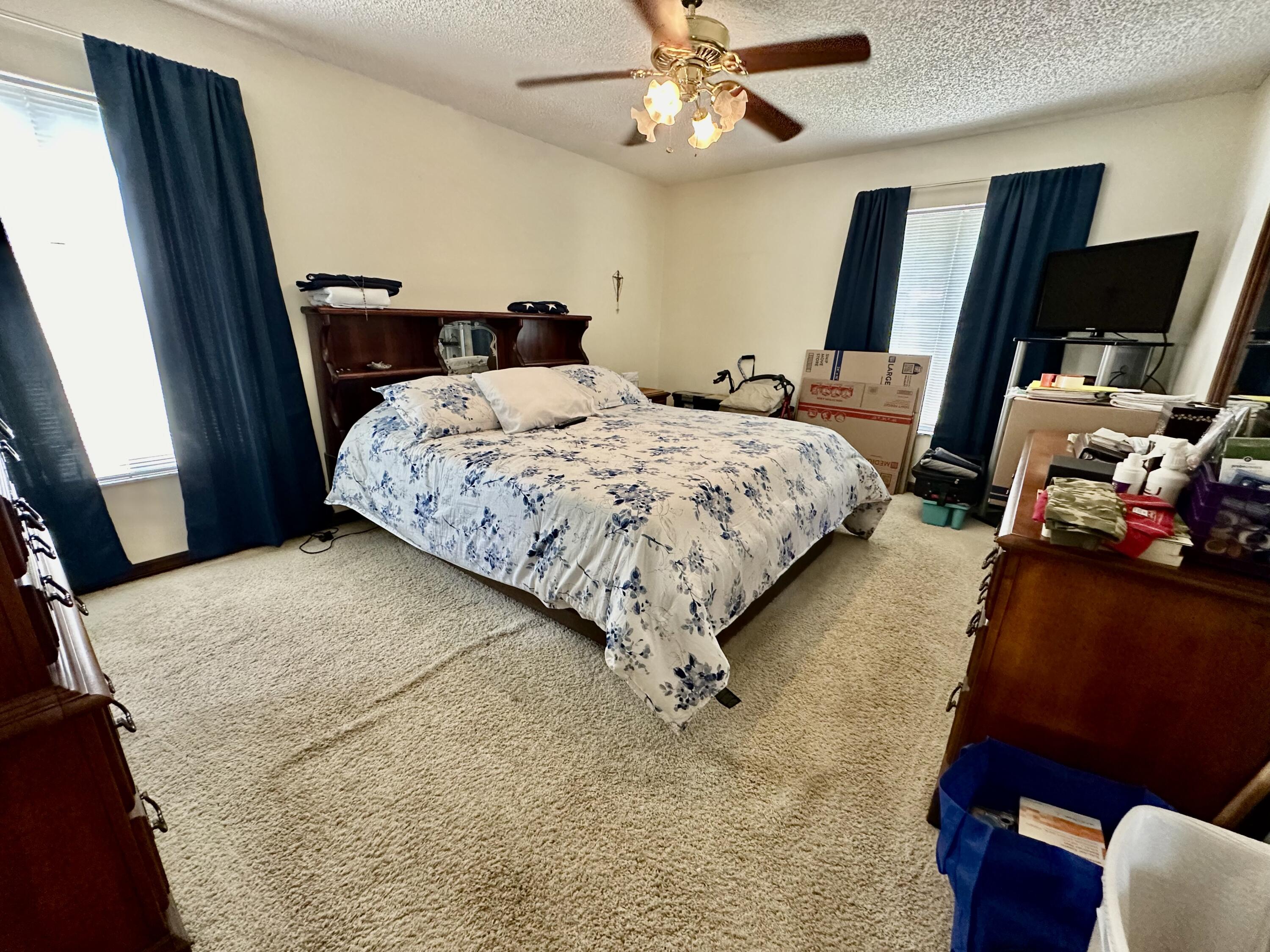 4980 Bridge Road Cocoa, FL 32927 - Photo 14 of 24 a bedroom with a bed and large mirror