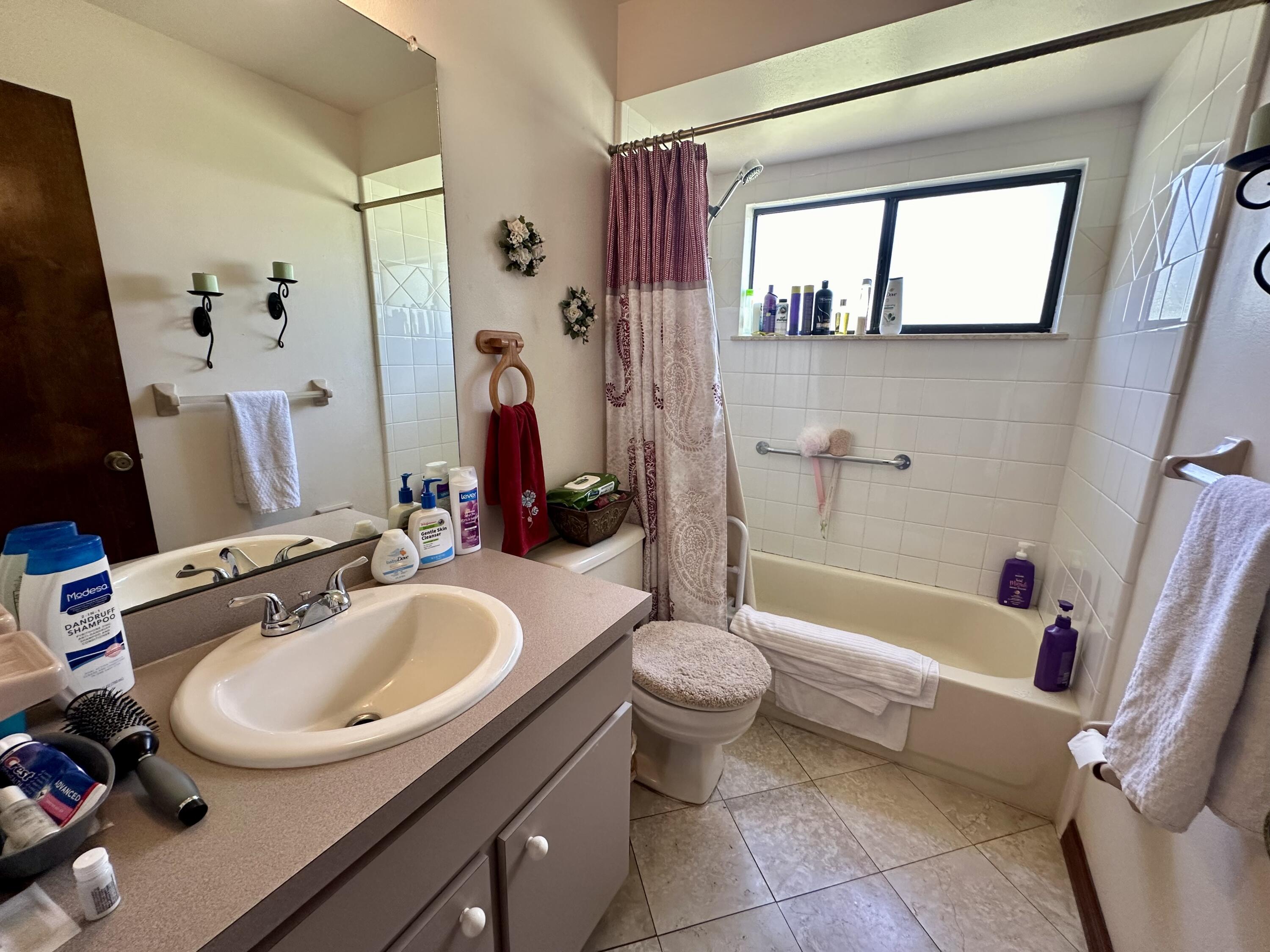 4980 Bridge Road Cocoa, FL 32927 - Photo 16 of 24 a bathroom with a sink toilet and shower